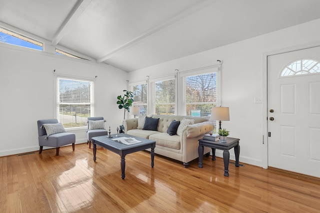 living room with hardwood / wood-style flooring and vaulted ceiling with beams