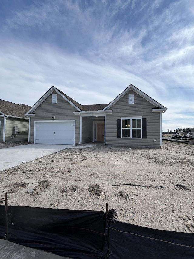 ranch-style house featuring a garage and concrete driveway