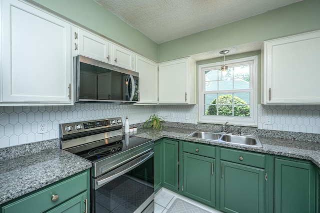 2016 Wild Flower Ln, Charleston, SC 29414 - kitchen featuring appliances with stainless steel finishes, green cabinets, a sink, white cabinets, and a textured ceiling