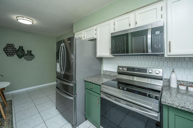 2016 Wild Flower Ln, Charleston, SC 29414 - kitchen with stainless steel appliances, white cabinetry, backsplash, green cabinets, and a textured ceiling