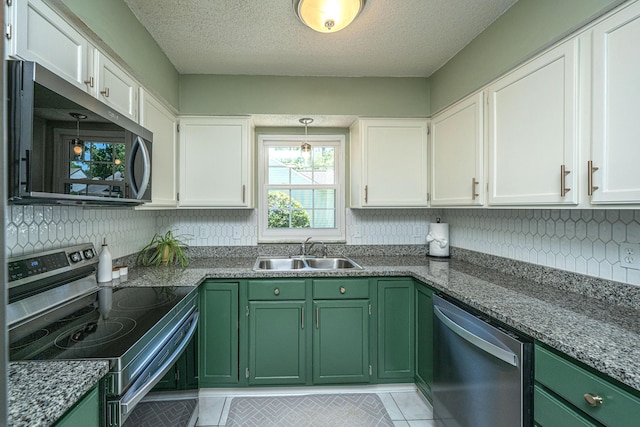 2016 Wild Flower Ln, Charleston, SC 29414 - kitchen with appliances with stainless steel finishes, green cabinets, a sink, white cabinetry, and a textured ceiling