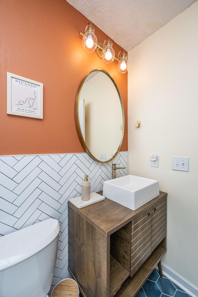2016 Wild Flower Ln, Charleston, SC 29414 - half bathroom featuring tile patterned flooring, a textured ceiling, vanity, and toilet