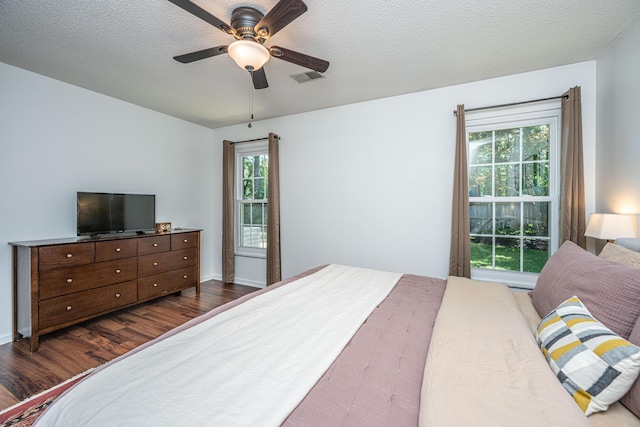 2016 Wild Flower Ln, Charleston, SC 29414 - bedroom featuring dark wood-style floors, a ceiling fan, and a textured ceiling