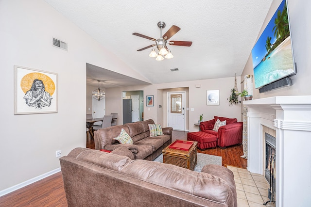 2016 Wild Flower Ln, Charleston, SC 29414 - living room with a ceiling fan, vaulted ceiling, a fireplace with flush hearth, wood finished floors, and a textured ceiling