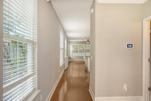 corridor with hardwood / wood-style flooring and baseboards