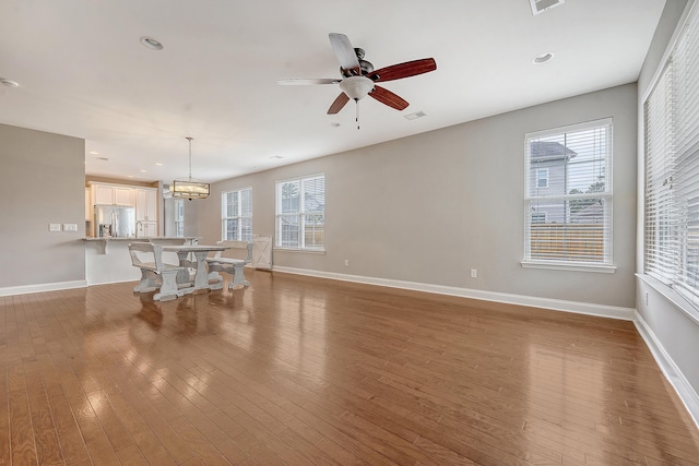 unfurnished living room featuring wood finished floors, ceiling fan, baseboards, and recessed lighting