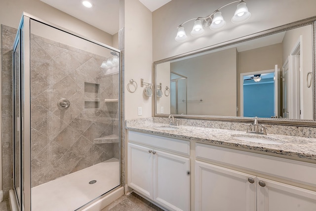 bathroom with a stall shower and double vanity