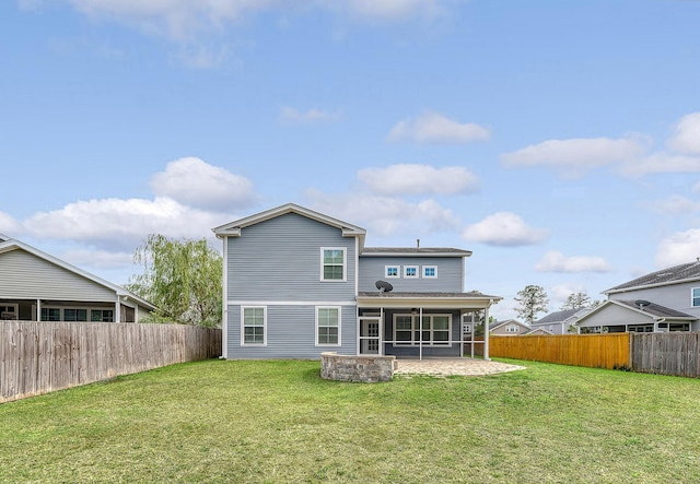 rear view of property featuring a sunroom and a patio