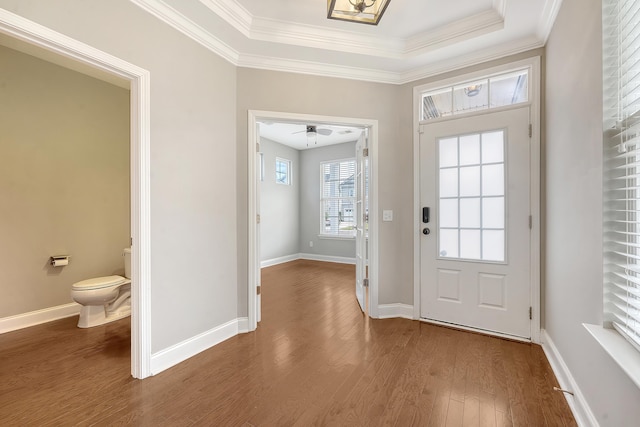entrance foyer with wood finished floors, ornamental molding, baseboards, and a ceiling fan