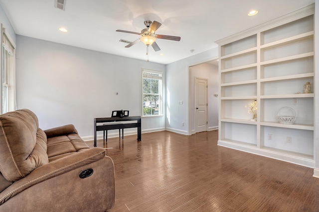 living room with ceiling fan, dark hardwood / wood-style flooring, and built in features