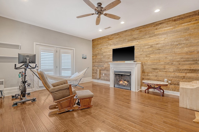 exercise room with light wood-type flooring and ceiling fan