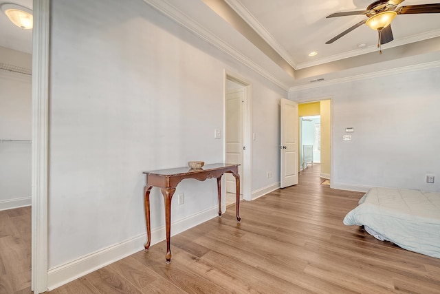 bedroom featuring ceiling fan, ornamental molding, and light hardwood / wood-style flooring