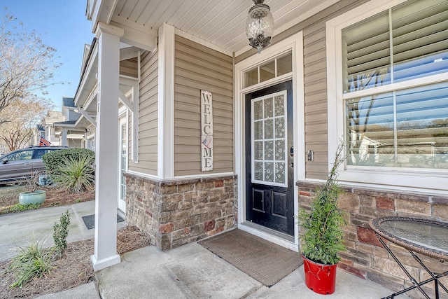 view of exterior entry featuring a porch