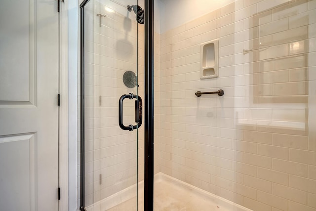 bathroom with a shower with shower door