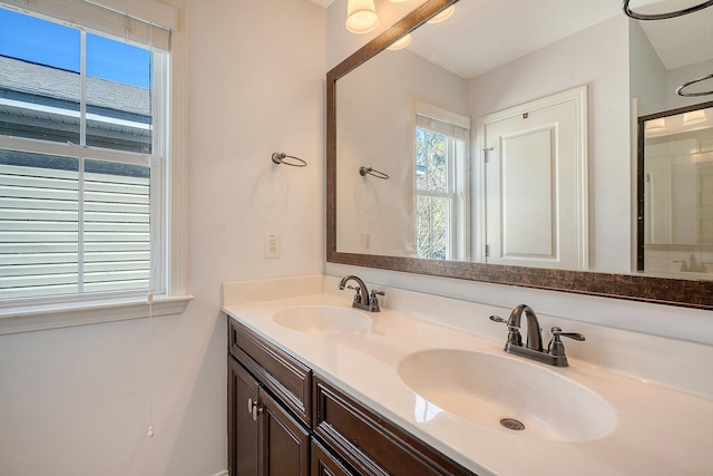 bathroom featuring vanity and a shower with door