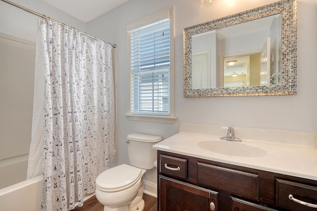 full bathroom featuring vanity, hardwood / wood-style flooring, toilet, and shower / tub combo with curtain