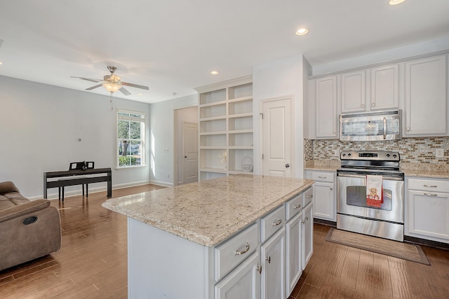 kitchen featuring white cabinetry, a center island, and appliances with stainless steel finishes