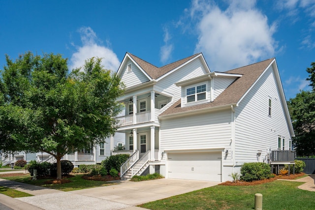 2242 Dewees Creek Dr, Mount Pleasant, SC 29466 - view of front of house featuring a porch, a garage, a shingled roof, a balcony, and concrete driveway