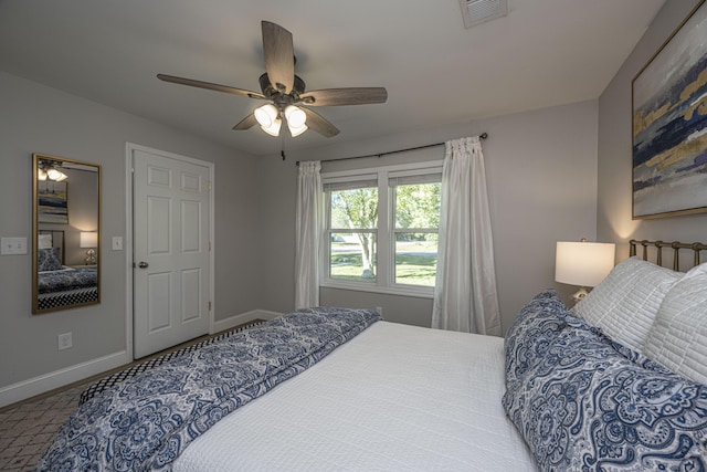 bedroom with visible vents, baseboards, and ceiling fan