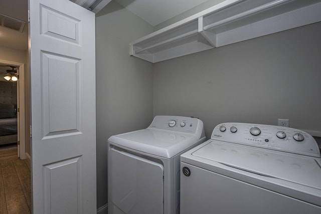 laundry area featuring laundry area, washing machine and dryer, visible vents, and dark wood-style floors