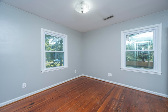 unfurnished room with hardwood / wood-style flooring