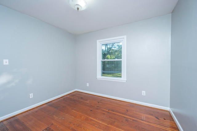 unfurnished room featuring hardwood / wood-style flooring