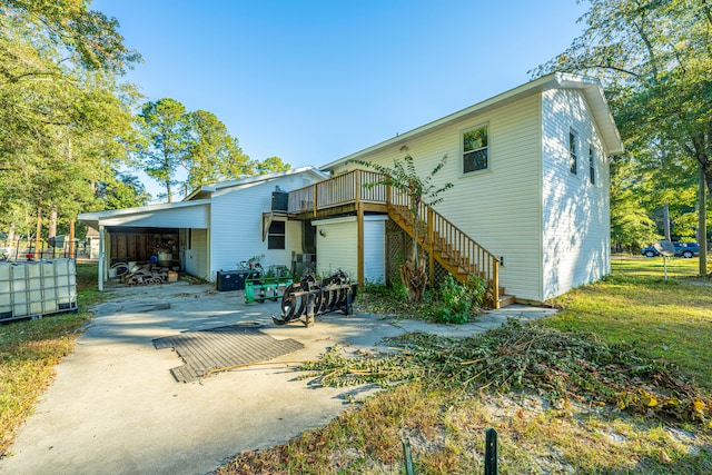 rear view of house featuring a yard and a carport