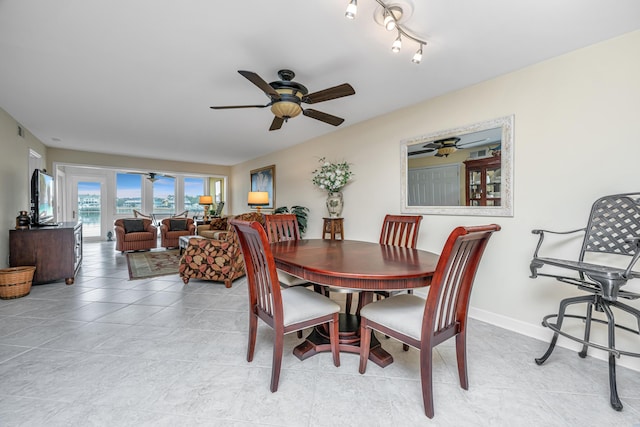 tiled dining room with ceiling fan