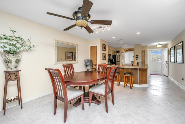 dining space with ceiling fan and light tile patterned flooring