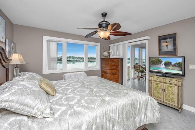 tiled bedroom featuring ceiling fan