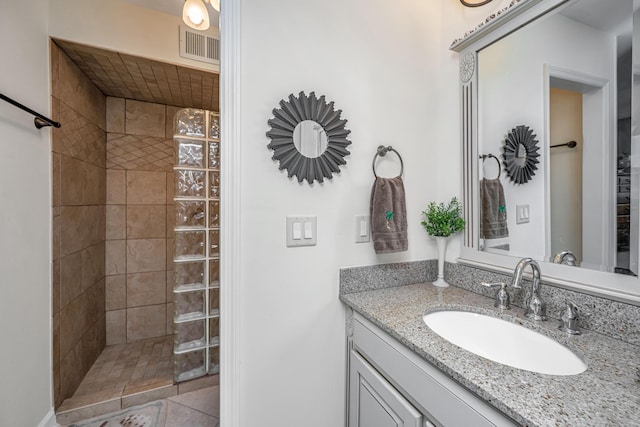 bathroom featuring vanity and a tile shower