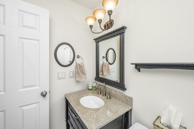 bathroom featuring vanity and a chandelier