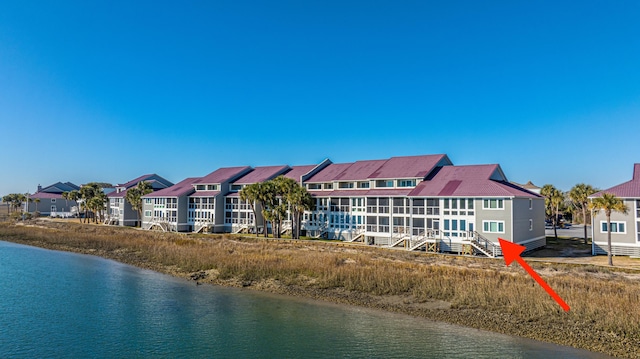 back of house with a water view