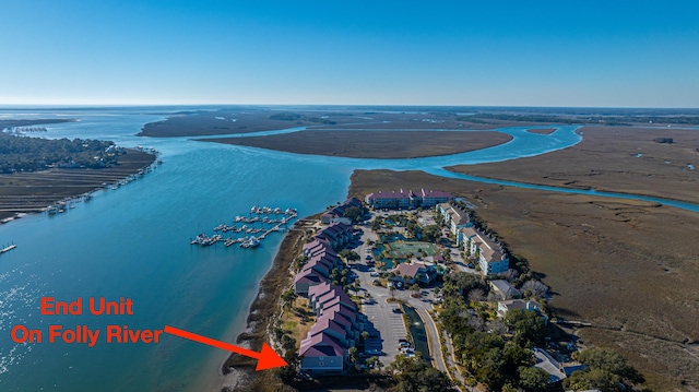 drone / aerial view with a water view and a view of the beach