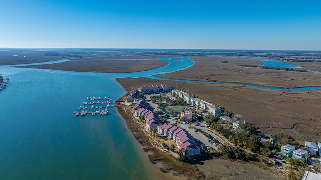 birds eye view of property with a water view and a view of the beach