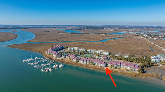 birds eye view of property with a water view and a beach view