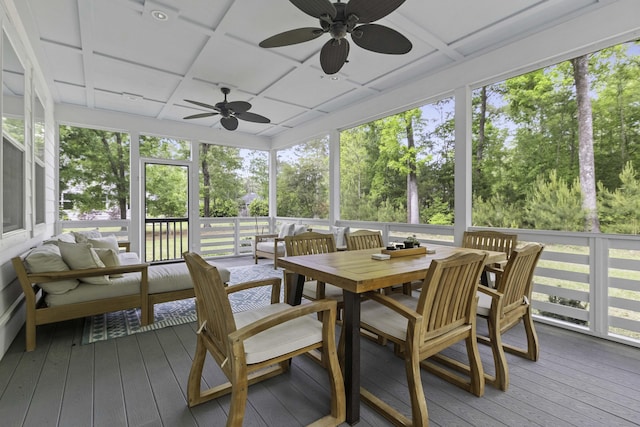 sunroom / solarium featuring coffered ceiling, outdoor lounge area, a ceiling fan, and outdoor dining area