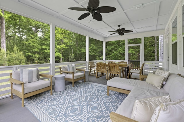 sunroom / solarium featuring a ceiling fan and outdoor lounge area