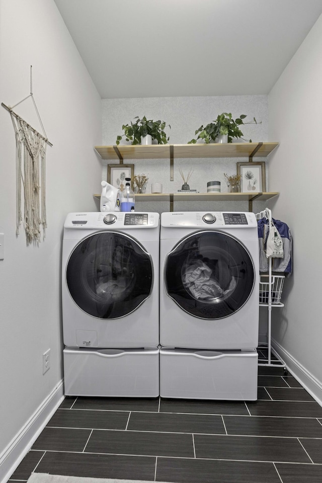 laundry room featuring baseboards, laundry area, wood finish floors, and independent washer and dryer