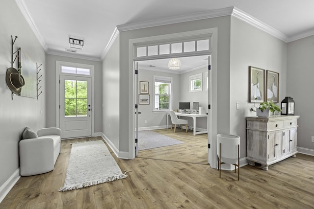 foyer with baseboards, ornamental molding, wood finished floors, and visible vents