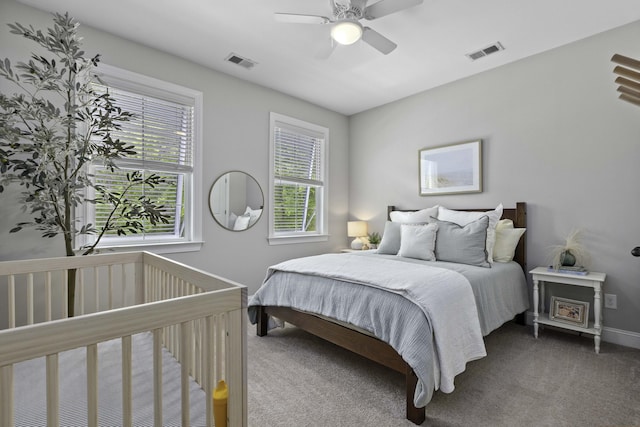 carpeted bedroom featuring visible vents, baseboards, and ceiling fan