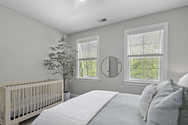 bedroom featuring a ceiling fan, baseboards, and visible vents