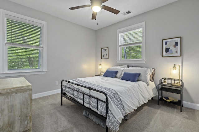 bedroom featuring carpet flooring, a ceiling fan, baseboards, and visible vents