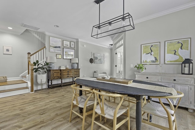 dining room featuring visible vents, stairs, light wood finished floors, ornamental molding, and recessed lighting