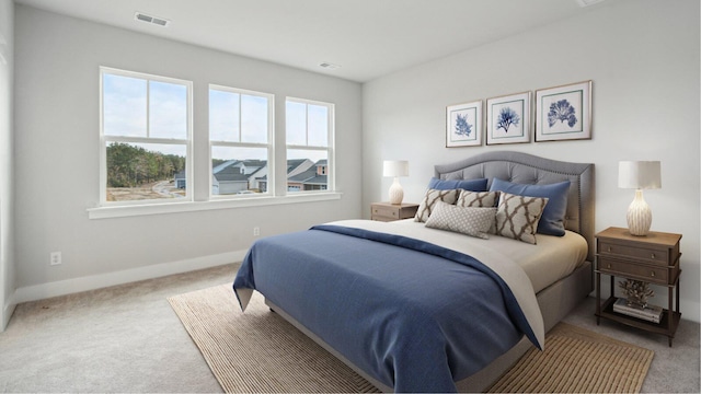 carpeted bedroom with visible vents and baseboards