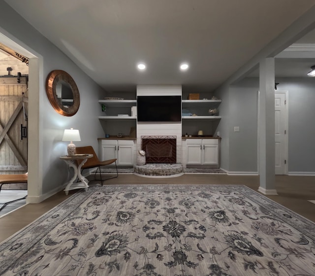 712 Nora Ln, Mount Pleasant, SC 29464 - living area with baseboards, a brick fireplace, recessed lighting, a barn door, and wood finished floors