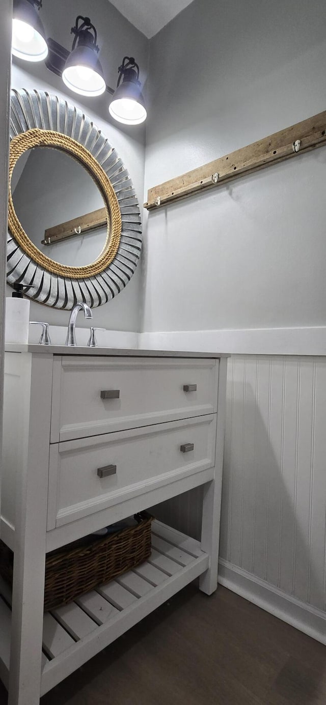 712 Nora Ln, Mount Pleasant, SC 29464 - bathroom view of wood finished floors, vanity, and a wainscoted wall