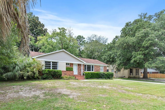 ranch-style home with a front yard