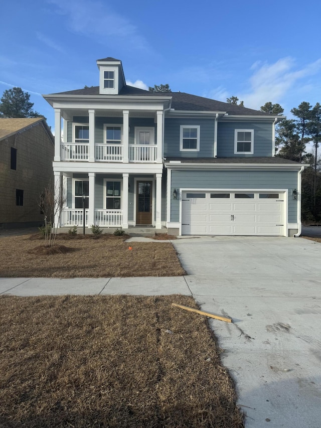 view of front of home with a garage, covered porch, and driveway