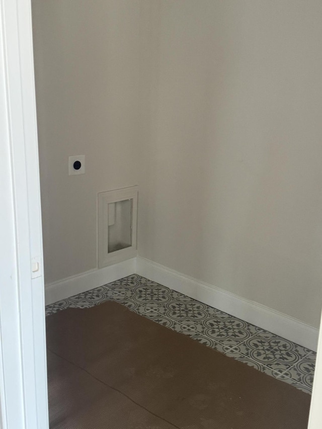 laundry room featuring laundry area, tile patterned flooring, electric dryer hookup, and baseboards